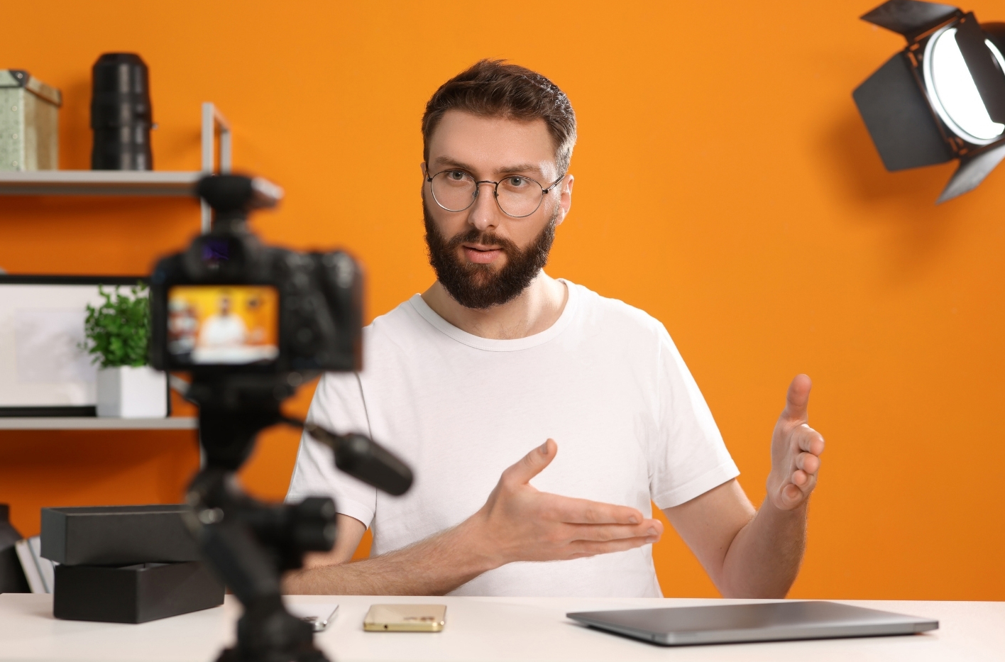 back of male asian producer arranging a song in home studio, music production technology concept